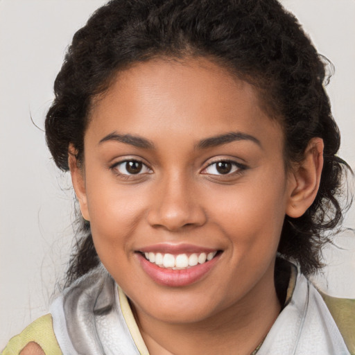 Joyful latino young-adult female with medium  brown hair and brown eyes