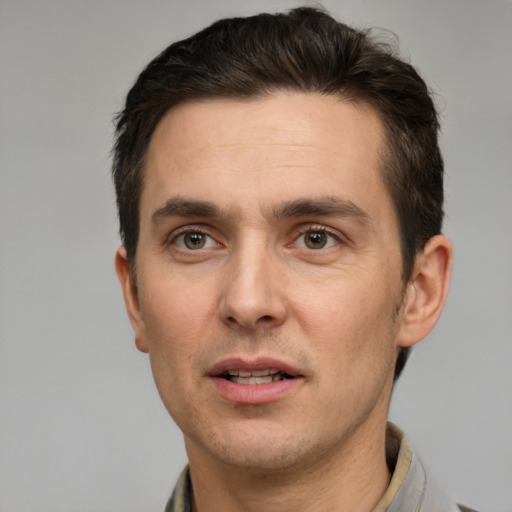 Joyful white adult male with short  brown hair and brown eyes