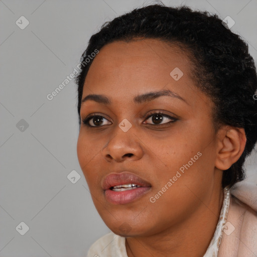 Joyful black young-adult female with short  black hair and brown eyes