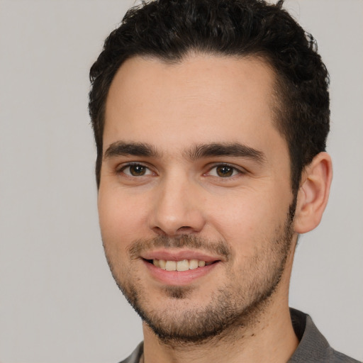 Joyful white young-adult male with short  black hair and brown eyes