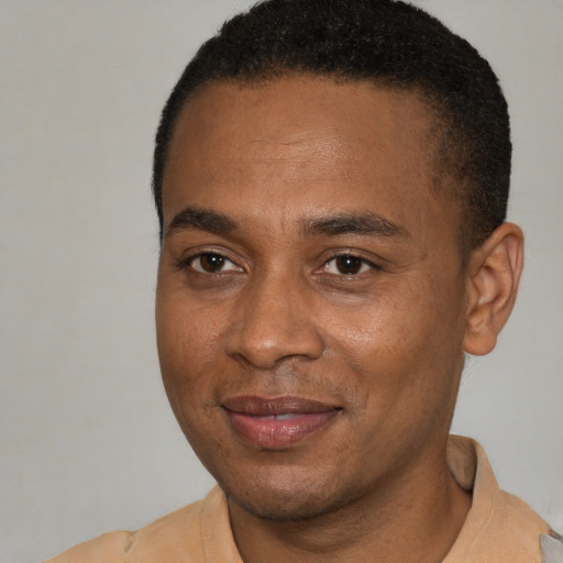 Joyful latino adult male with short  brown hair and brown eyes