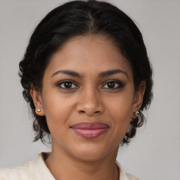 Joyful black young-adult female with medium  brown hair and brown eyes