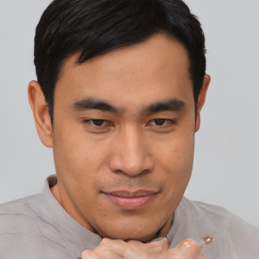 Joyful asian young-adult male with short  black hair and brown eyes