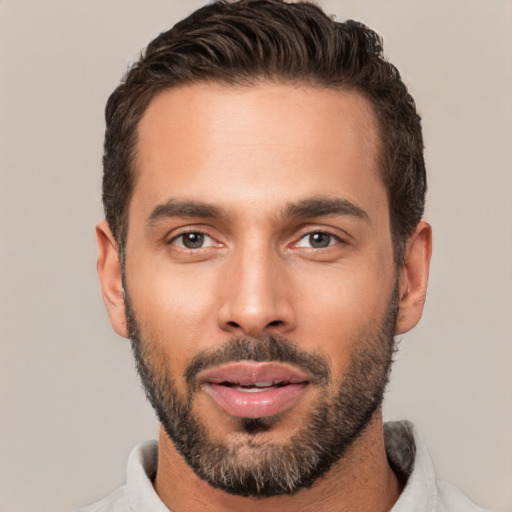 Joyful white young-adult male with short  black hair and brown eyes