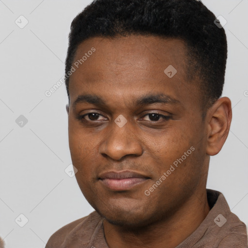 Joyful black young-adult male with short  black hair and brown eyes