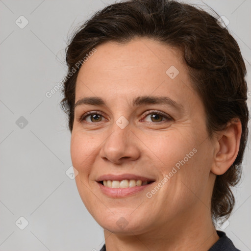 Joyful white adult female with medium  brown hair and brown eyes