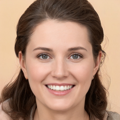 Joyful white young-adult female with medium  brown hair and brown eyes