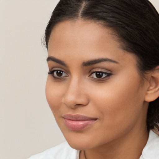 Joyful latino young-adult female with medium  brown hair and brown eyes