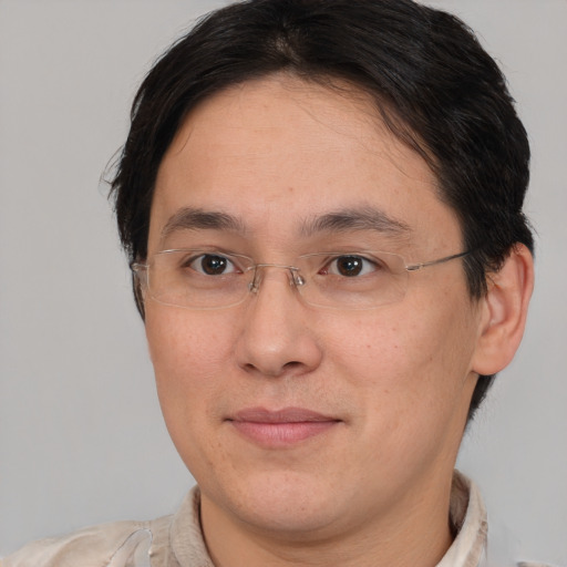 Joyful asian adult male with short  brown hair and brown eyes