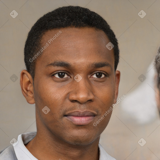 Joyful black young-adult male with short  brown hair and brown eyes