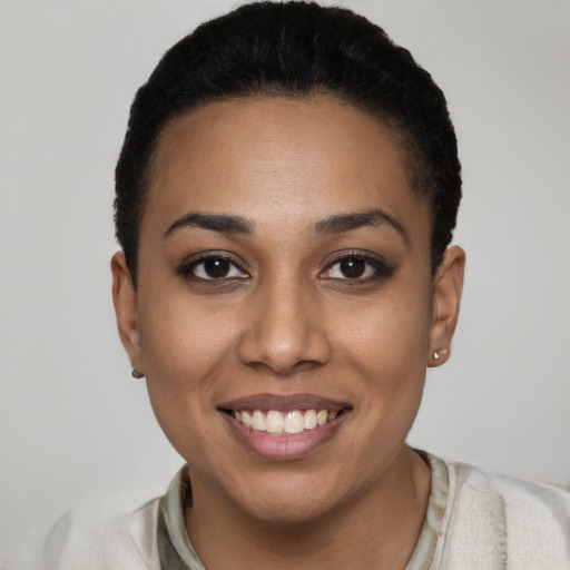 Joyful latino young-adult female with short  black hair and brown eyes