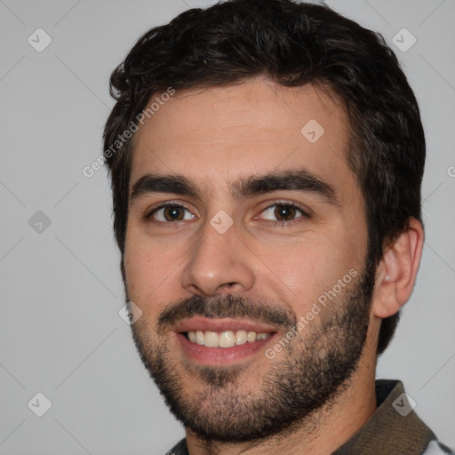 Joyful white young-adult male with short  black hair and brown eyes