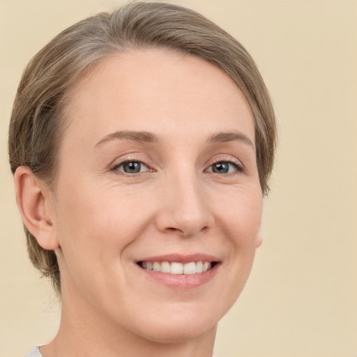 Joyful white young-adult female with short  brown hair and grey eyes