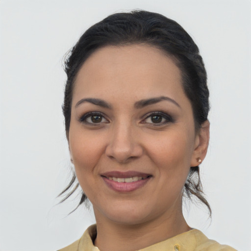 Joyful latino young-adult female with medium  brown hair and brown eyes