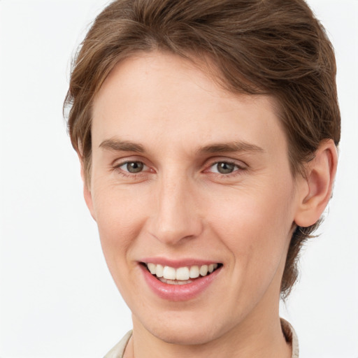 Joyful white young-adult female with short  brown hair and grey eyes