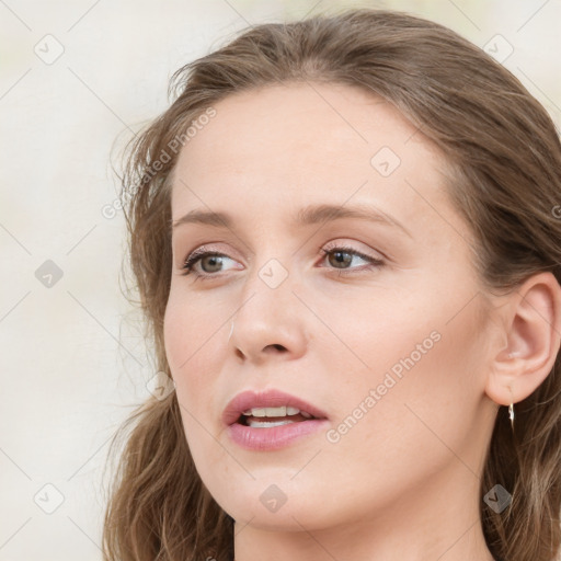 Joyful white young-adult female with long  brown hair and blue eyes