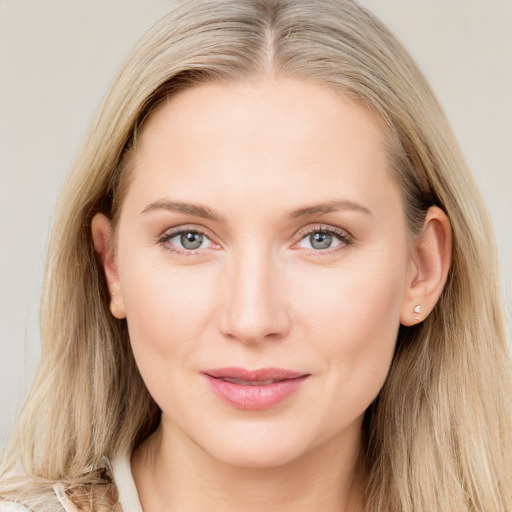 Joyful white young-adult female with long  brown hair and blue eyes