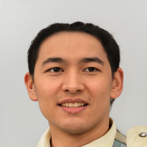 Joyful latino young-adult male with short  brown hair and brown eyes