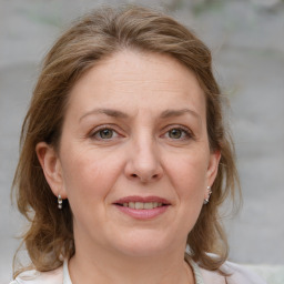 Joyful white adult female with medium  brown hair and grey eyes