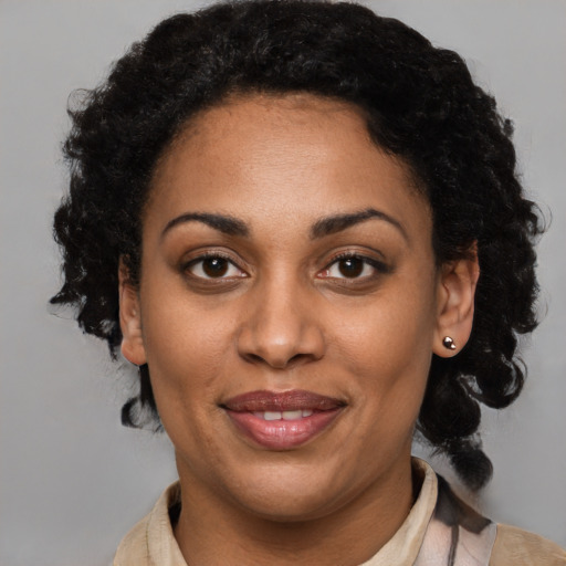 Joyful black young-adult female with medium  brown hair and brown eyes