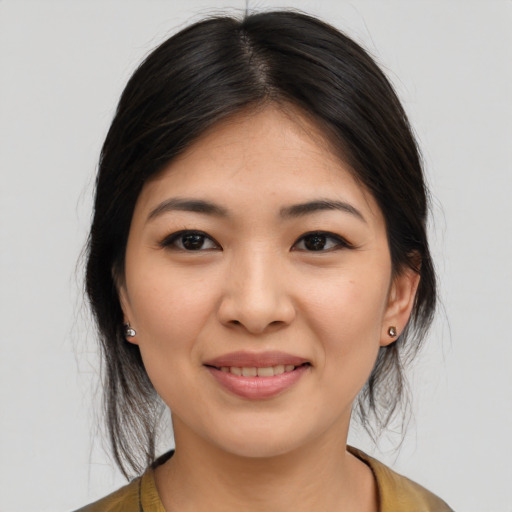 Joyful asian young-adult female with medium  brown hair and brown eyes