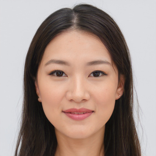 Joyful asian young-adult female with long  brown hair and brown eyes