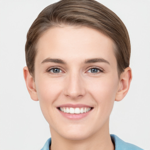 Joyful white young-adult female with short  brown hair and grey eyes