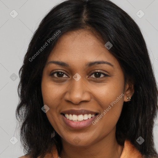 Joyful black young-adult female with long  brown hair and brown eyes