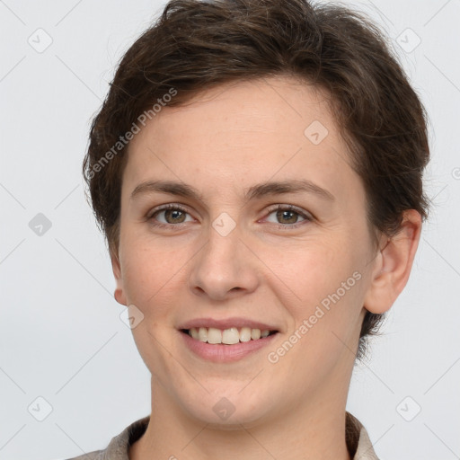 Joyful white young-adult female with short  brown hair and grey eyes