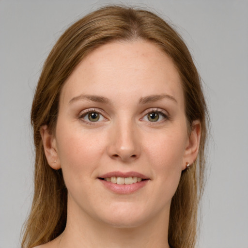 Joyful white young-adult female with medium  brown hair and green eyes