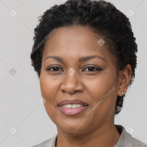 Joyful black adult female with short  brown hair and brown eyes