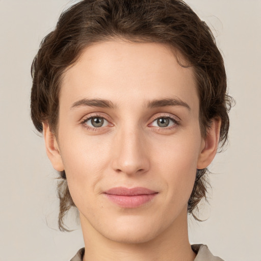 Joyful white young-adult female with medium  brown hair and green eyes