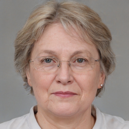 Joyful white middle-aged female with medium  blond hair and blue eyes