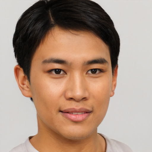 Joyful asian young-adult male with short  brown hair and brown eyes