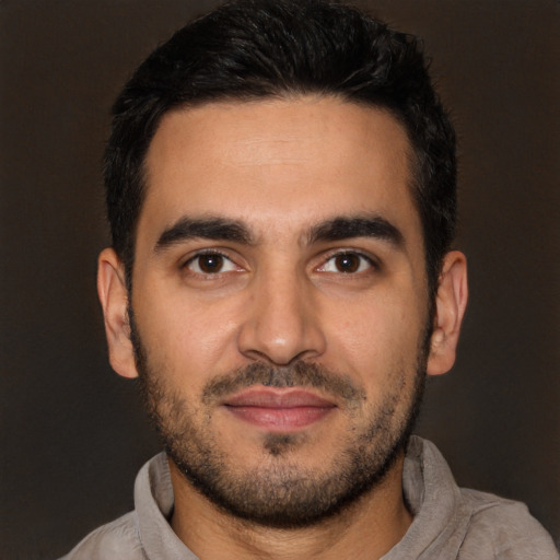Joyful latino young-adult male with short  black hair and brown eyes
