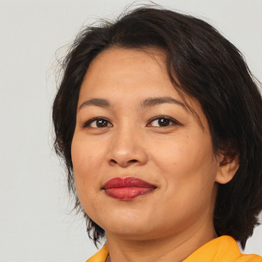 Joyful white adult female with medium  brown hair and brown eyes