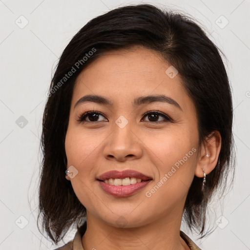 Joyful latino young-adult female with medium  brown hair and brown eyes