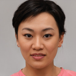 Joyful asian young-adult female with short  brown hair and brown eyes