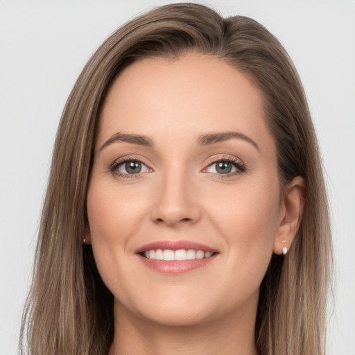 Joyful white young-adult female with long  brown hair and grey eyes