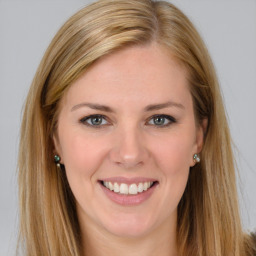 Joyful white young-adult female with long  brown hair and blue eyes