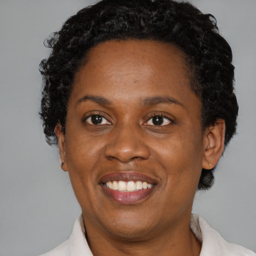 Joyful black adult female with short  brown hair and brown eyes