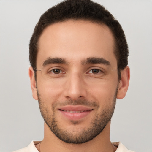 Joyful white young-adult male with short  brown hair and brown eyes