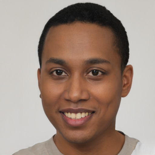 Joyful black young-adult male with short  brown hair and brown eyes