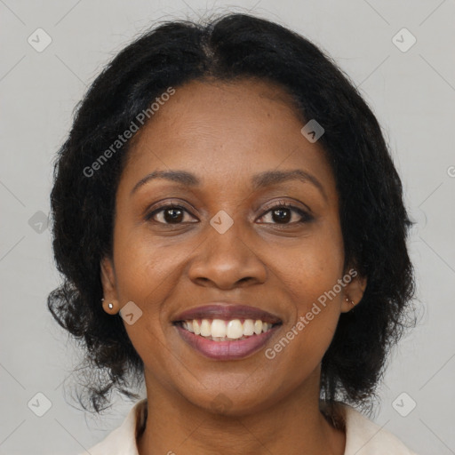 Joyful black adult female with medium  brown hair and brown eyes