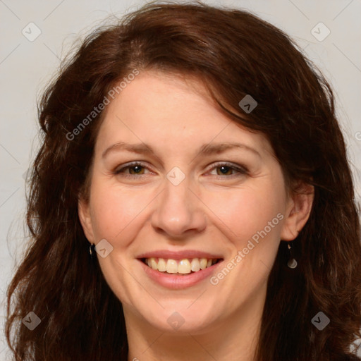 Joyful white adult female with long  brown hair and brown eyes