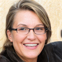 Joyful white adult female with medium  brown hair and blue eyes