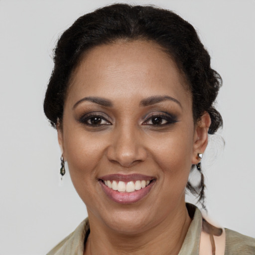 Joyful latino adult female with medium  brown hair and brown eyes