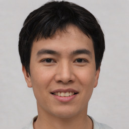 Joyful asian young-adult male with short  black hair and brown eyes