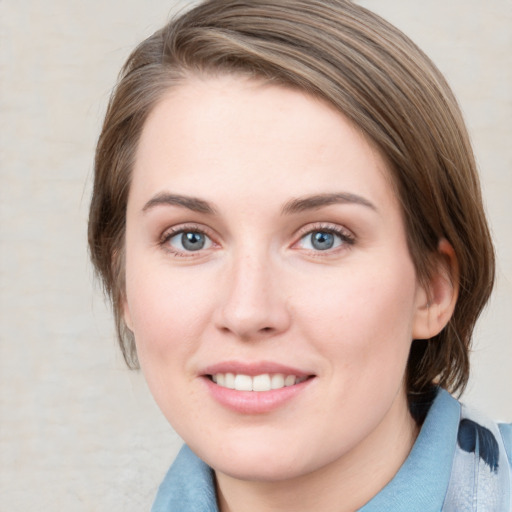 Joyful white young-adult female with medium  brown hair and blue eyes