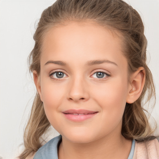 Joyful white child female with long  brown hair and brown eyes